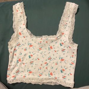 White floral crop top with lace trim, pink flowers with teal stems